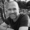 A black and white photograph of a man wearing a t-shirt