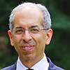 A man with grey hair wearing a suit jacket