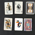 Six playing cards - three are from a standard deck and three advertise different products