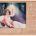 A girl sits up in bed and points to a lightbulb above her. The advert text is to the right of the image