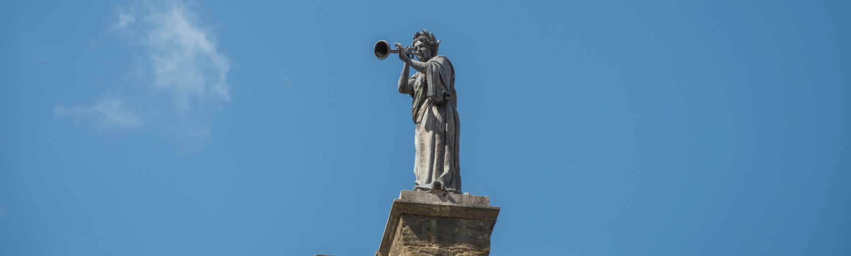 Statue of a woman against blue sky