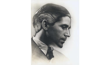 A photograph of a young man in profile