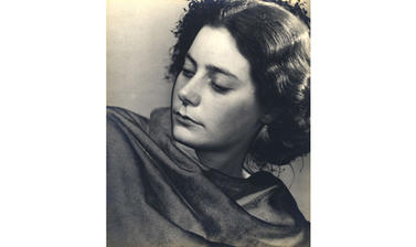 Photograph of a woman looking over her right shoulder 
