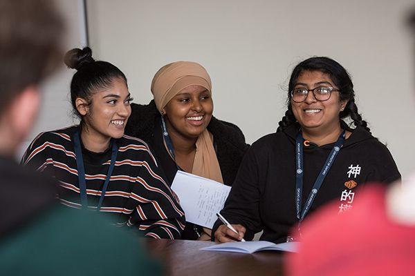 Group of smiling students giving a presentation