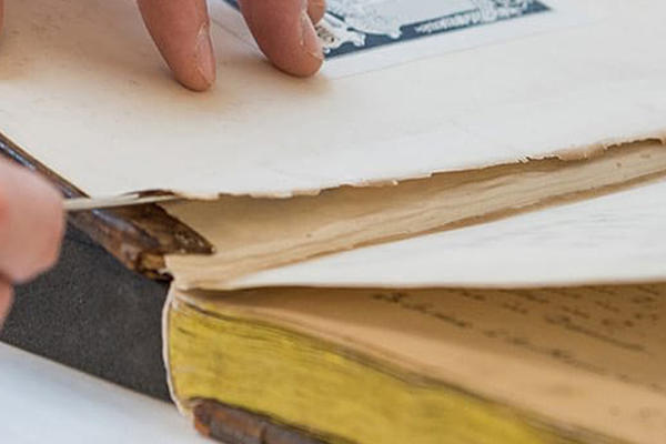 A damaged book being repaired
