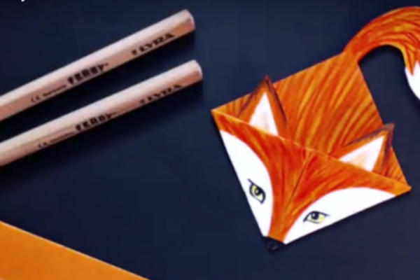 A hand-coloured orange fox bookmark on a navy background