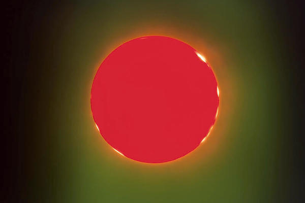 A circular region of bright red colour surrounded by lighter green and black