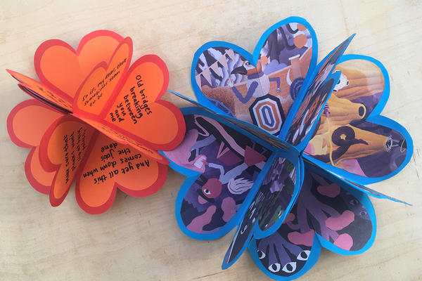 Image of two heart shaped paper craft items with handwritten text on one and images from a cartoon stuck on the other