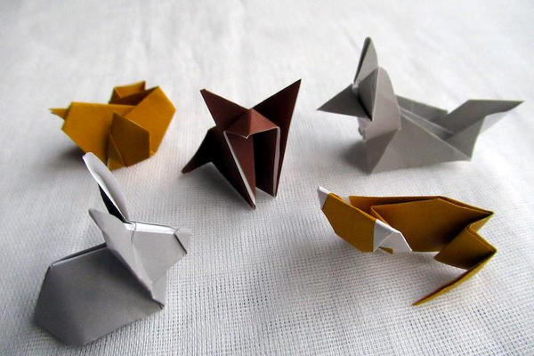 Five origami shapes made from different coloured paper