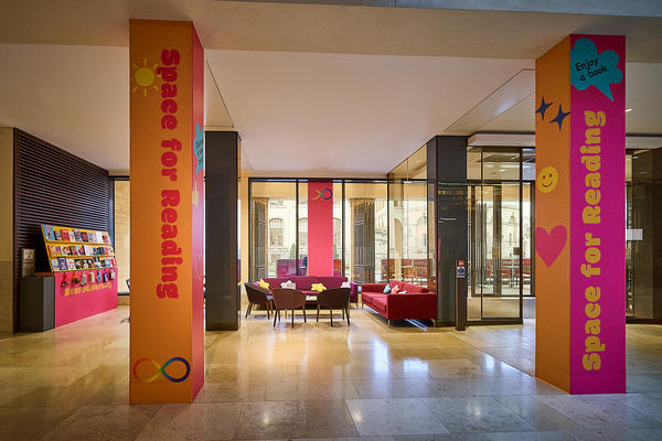 Two pink and yellow pillars showing the title "Space for Reading"