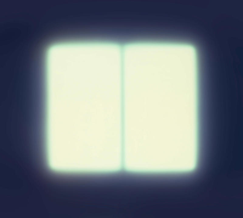 Two bright white squares next to each other fading to a dark blue background