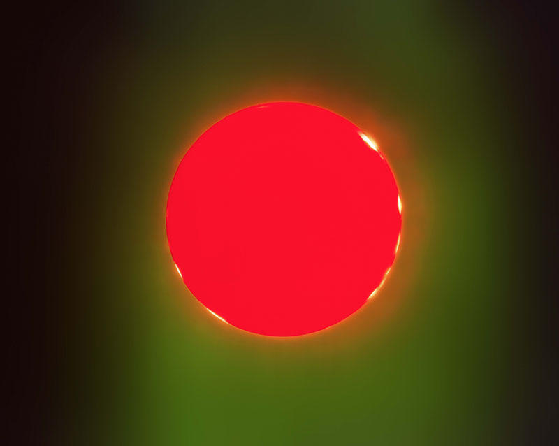 A circular region of bright red colour surrounded by lighter green and black