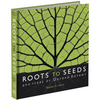 The front cover of the Roots to Seeds exhibition book - it has a vibrant green leaf design with the book title at the bottom on black
