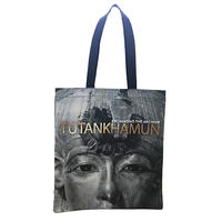A tote bag with a black and white image of Tutankhamun's death mask and 'Tutankhamun' in gold lettering